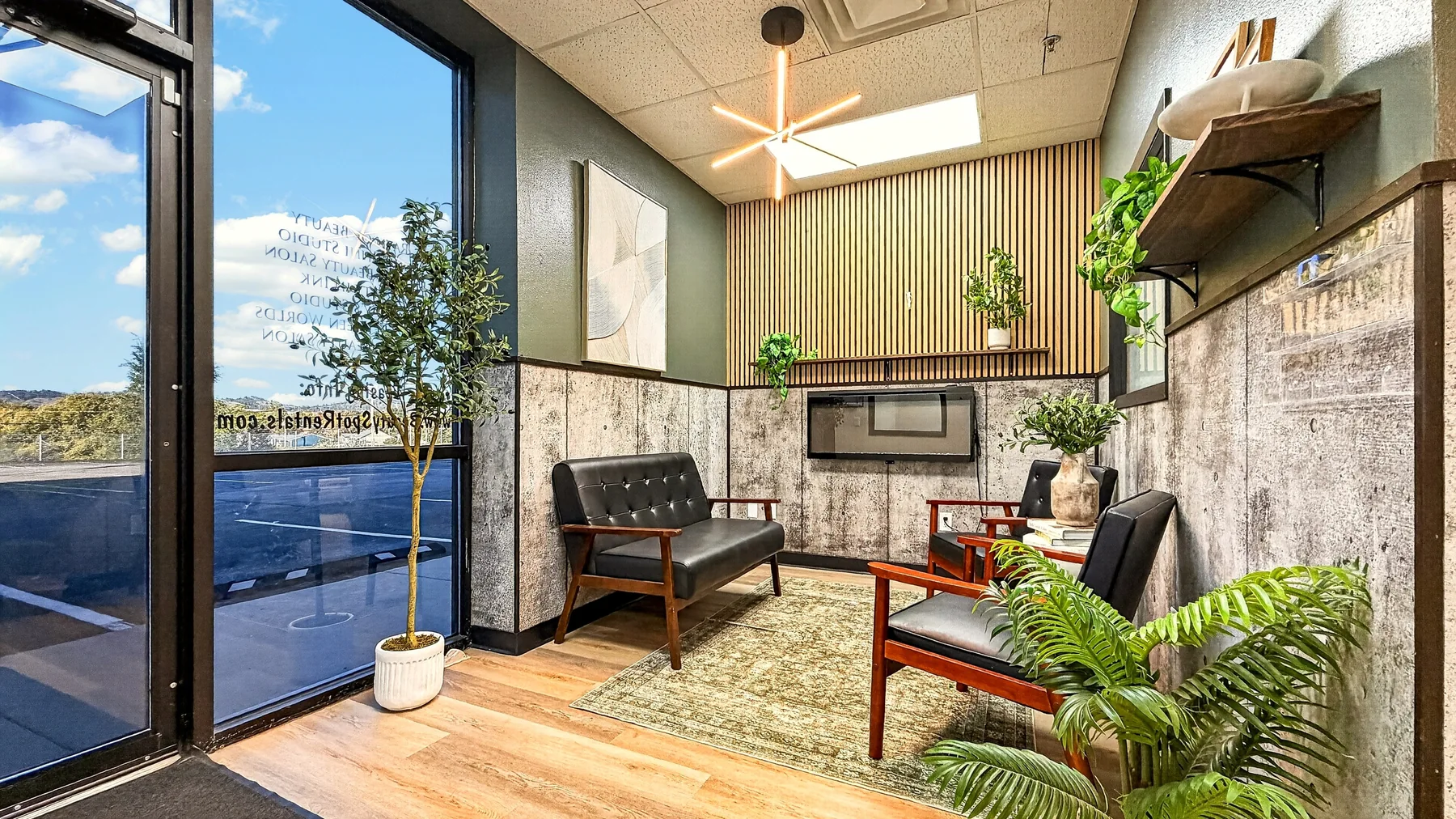 The Beauty Spot welcome lounge with upholstered chairs, plants, and glass entrance doors