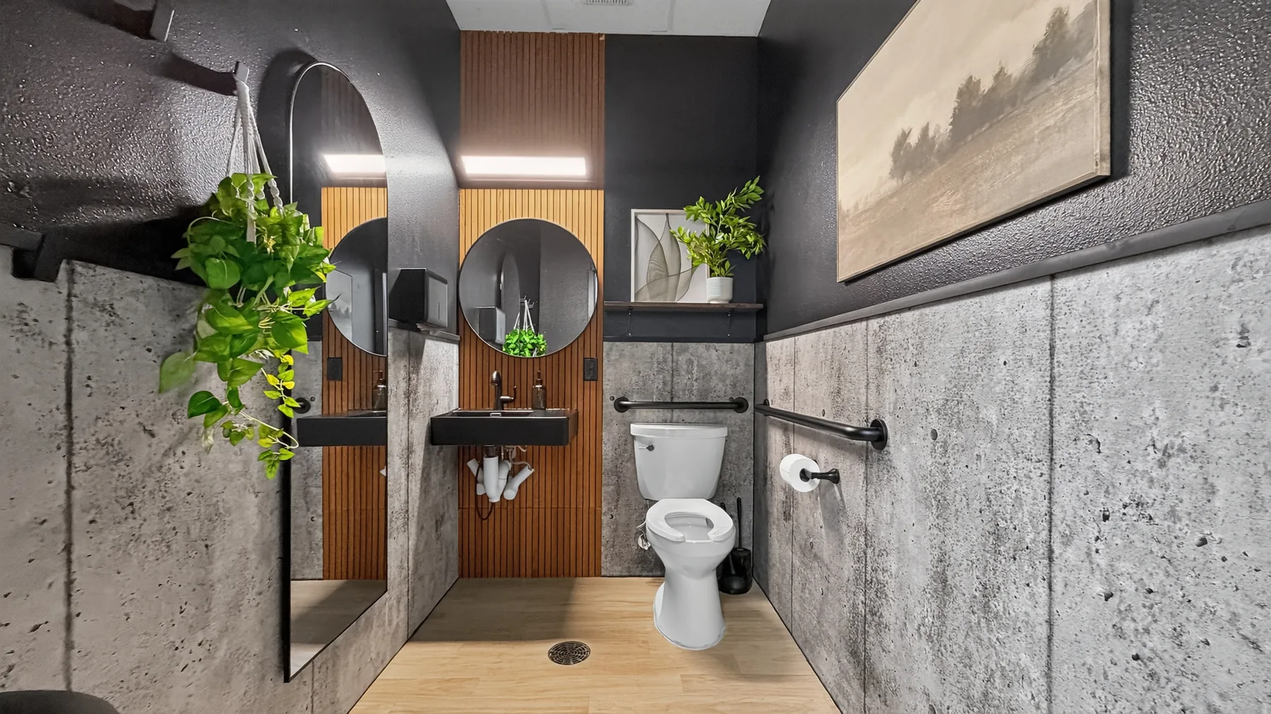 Shared restroom at The Beauty Spot with sink, mirror, and black door