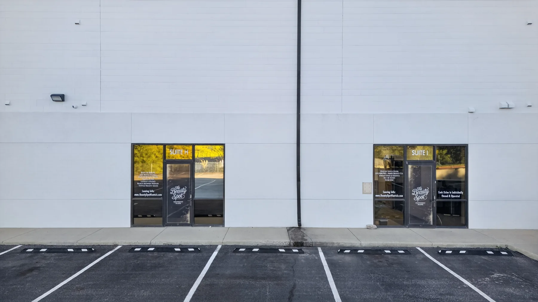 The Beauty Spot exterior entrances for Suites H and I with parking in front